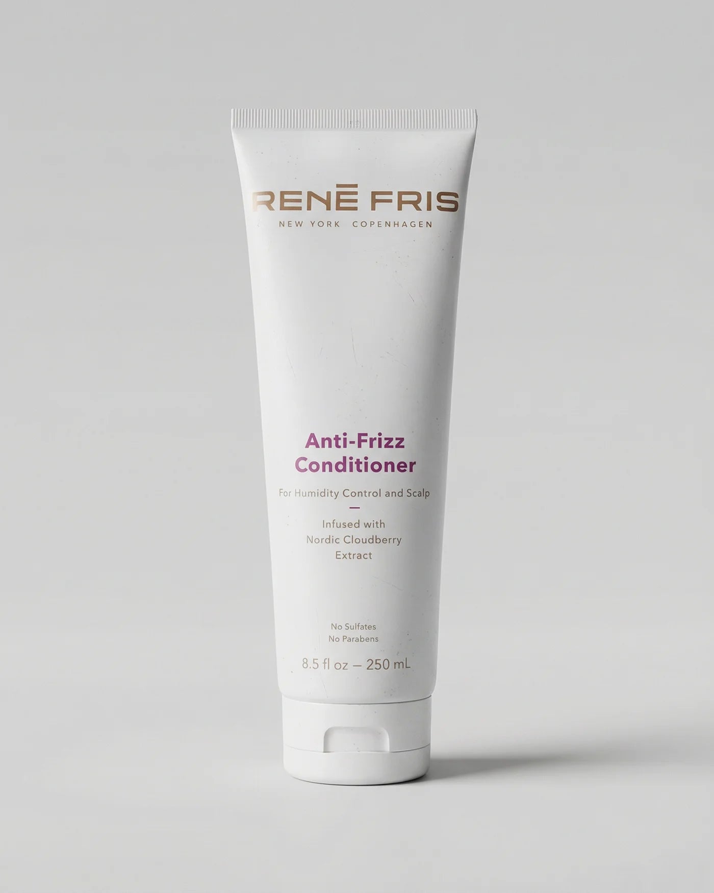 Tube of Rene Fris Anti-Frizz Conditioner on a light gray background