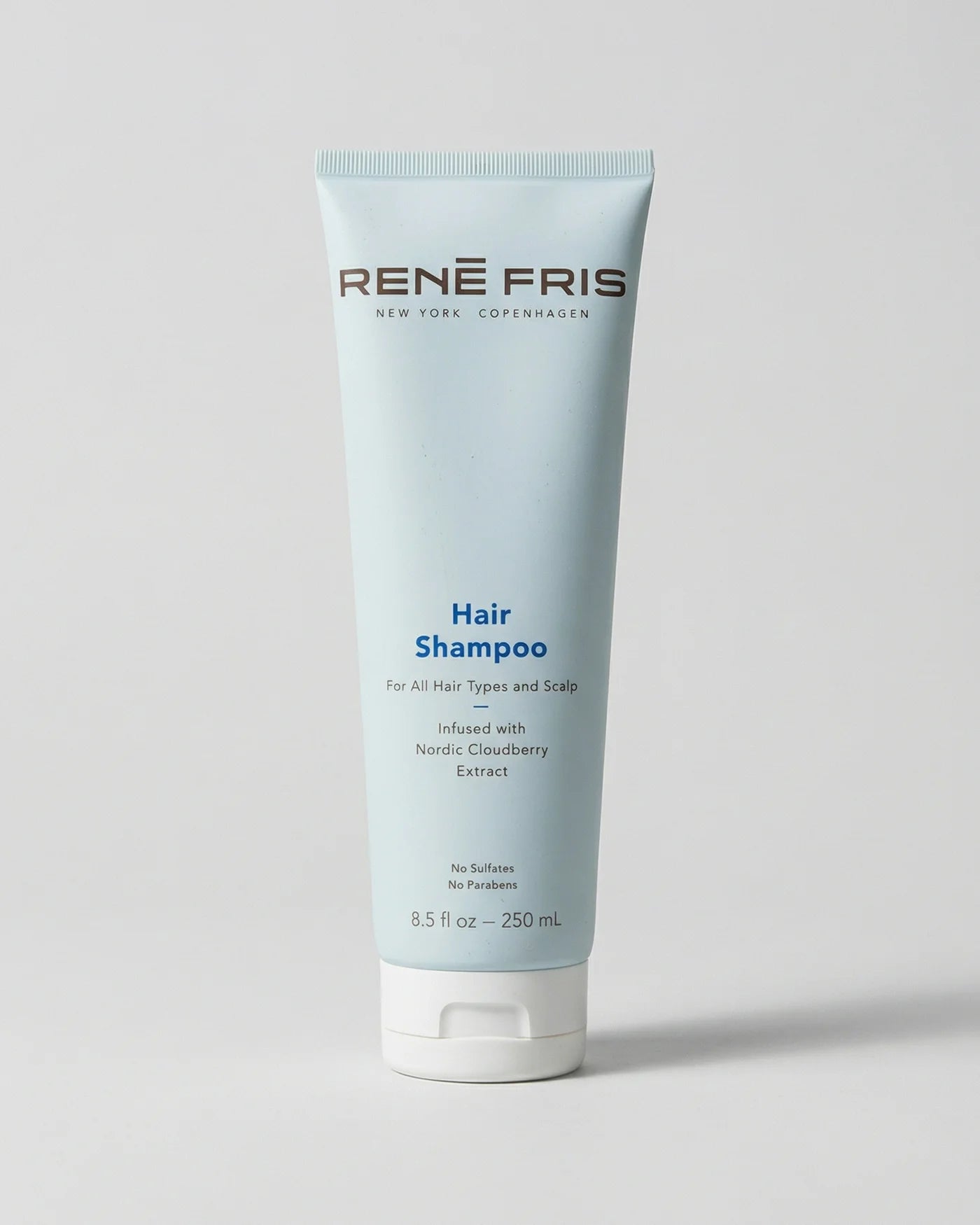 René Fris hair shampoo tube on a light gray background