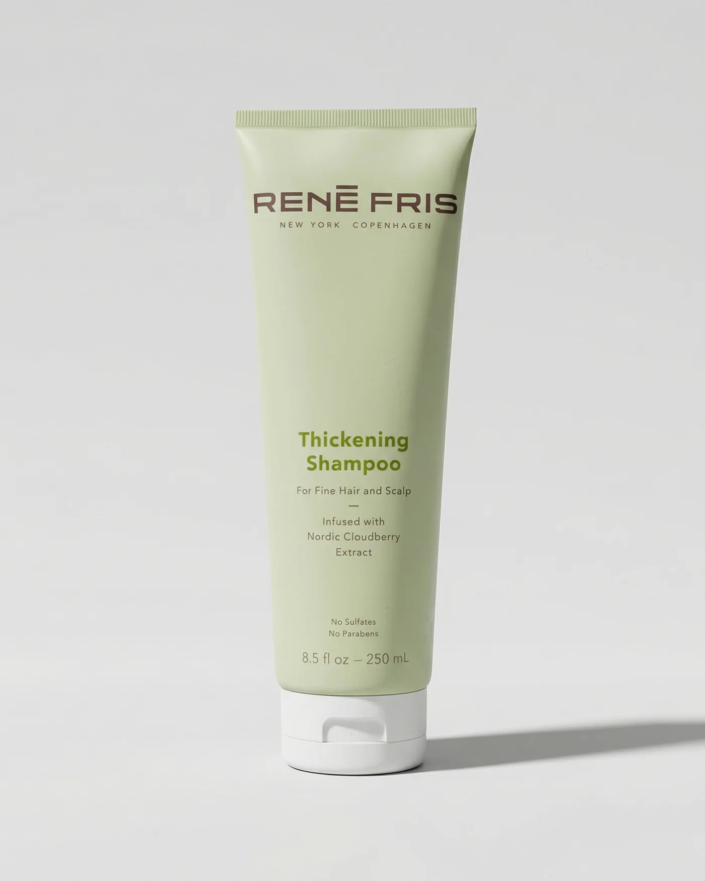 Tube of Rene Fris Thickening Shampoo on a light gray background