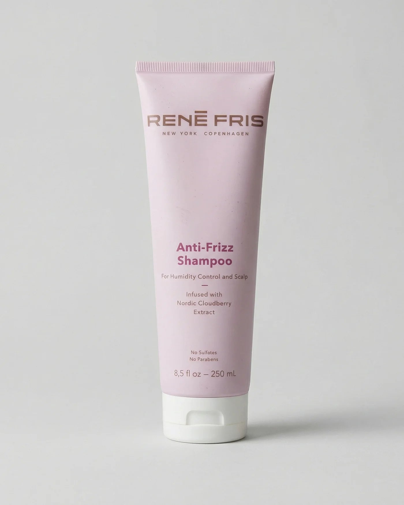 Pink shampoo bottle labeled 'Rene Fris Anti-Frizz Shampoo' on a light gray background