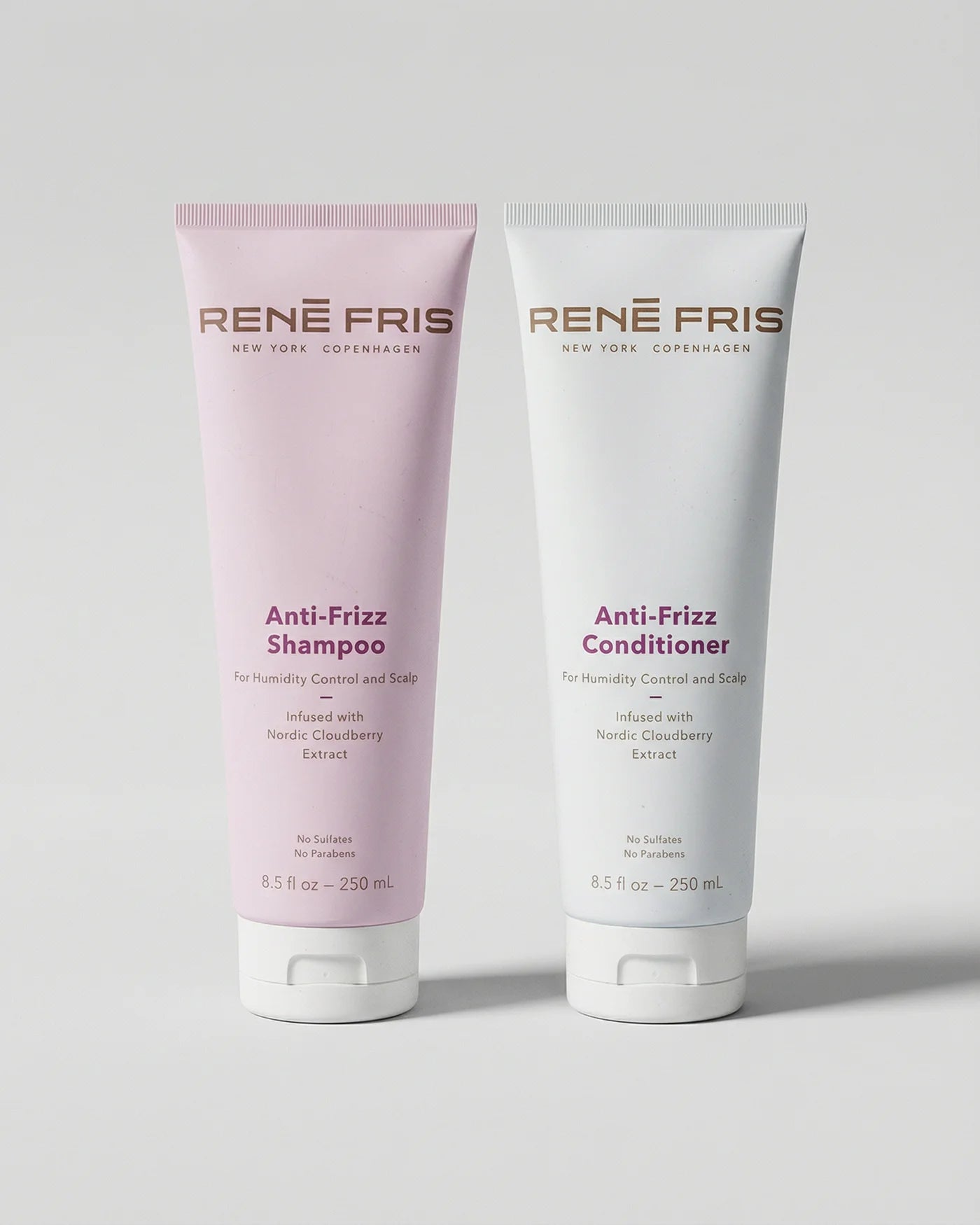 Two tubes of René Fris Anti-Frizz Shampoo and Conditioner on a light gray background